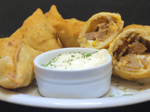 Donair Samosa Plate with Donair Dipping Sauce showing inside of a Donair Samosa