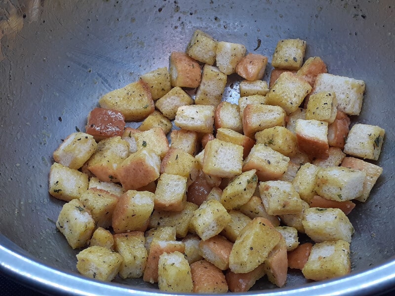 Tossing Croutons in Garlic Sauce and Seasoning