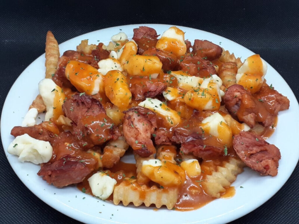 JAHZKITCHEN Chourico Poutine garnished with parsley