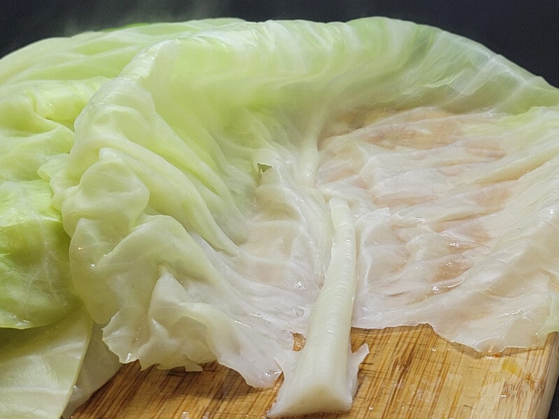 Slicing thick stem from cabbage leaf