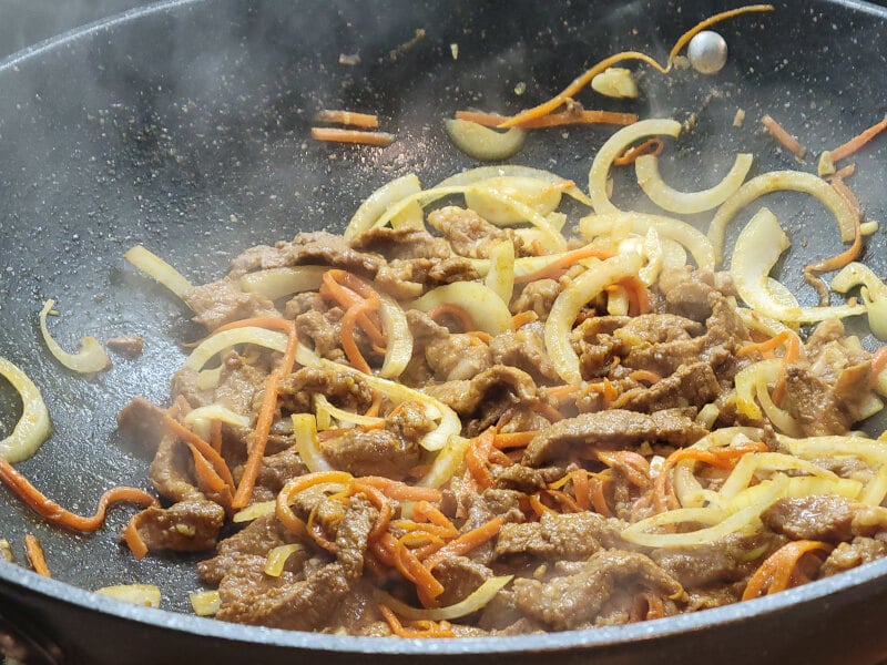 Wok Peanut Pad Thai Meat adding Onion, Garlic and Carrot to stir fry 3 minutes