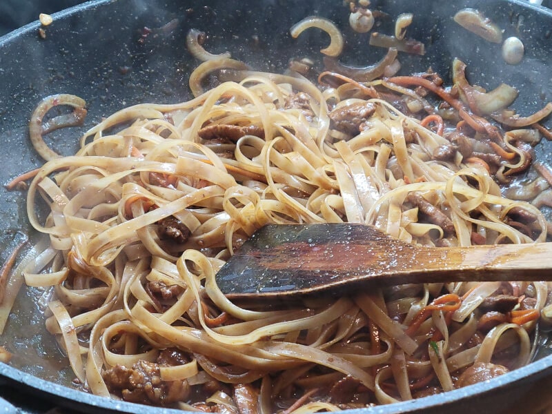 Wok Peanut Pad Thai adding Pad Thai Sauce and Noodles to cook for 4-5 minutes