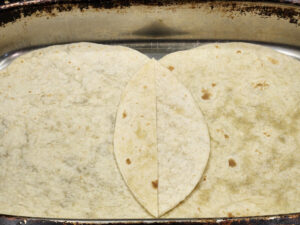 Slicing down the center where the tortillas overlap