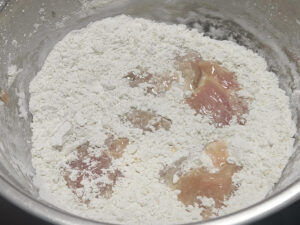 JAHZKITCHEN Tossing the Chicken pieces into the breading