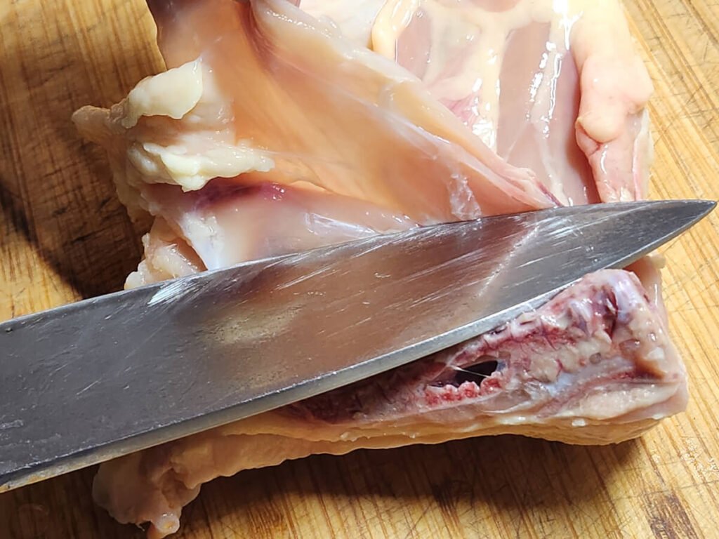 JAHZKITCHEN Slicing away the membrane underside from Chicken Quarters