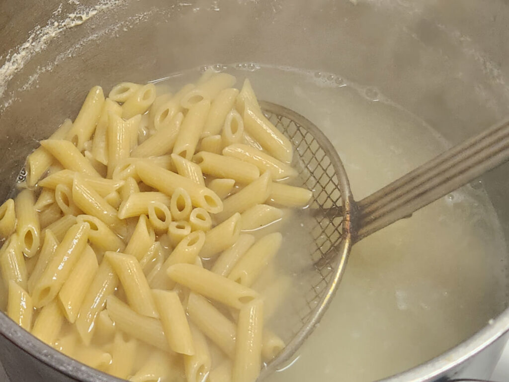 JAHZKITCHEN Scooping out Penne Pasta