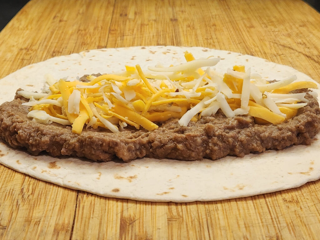 Adding Shredded Cheese Cheddar and Monterey Jack